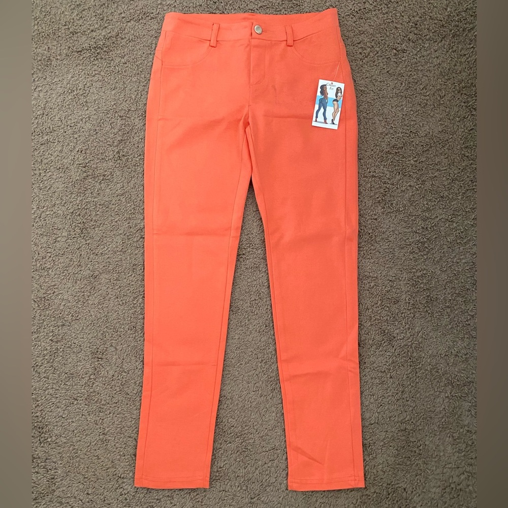 Orange skinny slacks.